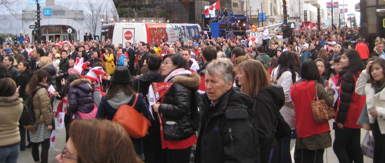 Crowds of people gathering on a city street